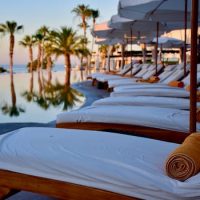 Experience luxury relaxation at a poolside resort in Cabo San Lucas, Mexico.